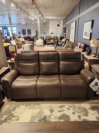The Donald Choi San Antonio Power Recliner Sofa-520356 features adjustable lumbar support and top grain brown leather.