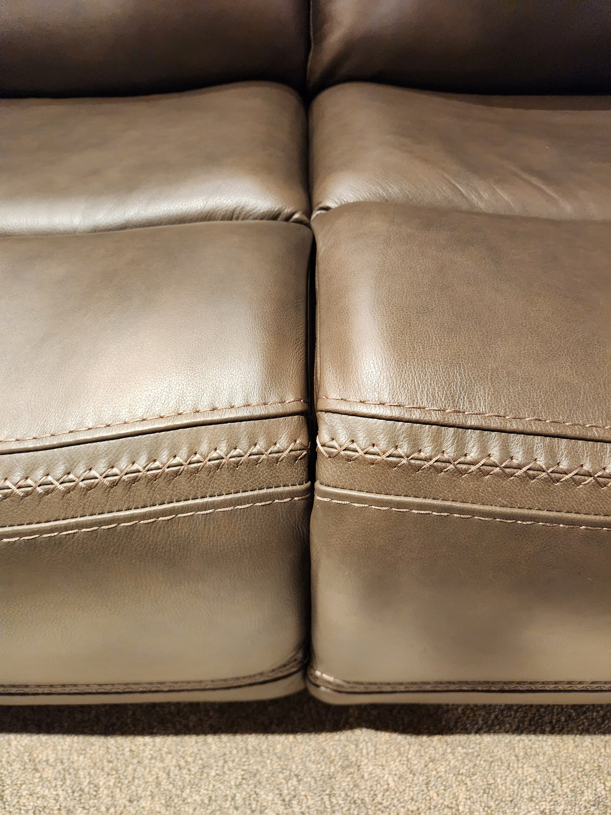 Close-up of two brown San Antonio Power Recliner Sofa cushions by Donald Choi with visible stitching and center seam.