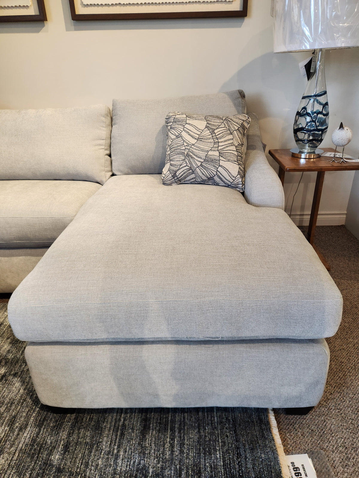 Light gray La-Z-Boy Charlie-638 Sectional with leaf pillow, paired with a side table for modern flair.