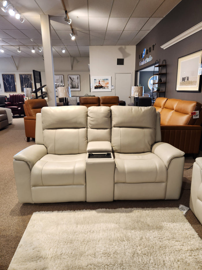 16 WEST Austin Power Recliner Loveseat-520157: beige leather, center console, lumbar support, in the showroom.