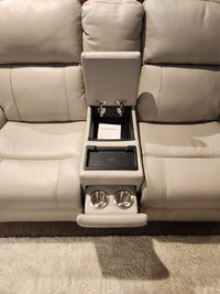 16 WEST Austin Power Recliner Loveseat-520157 in light beige with open center console, cup holders, storage, and document.