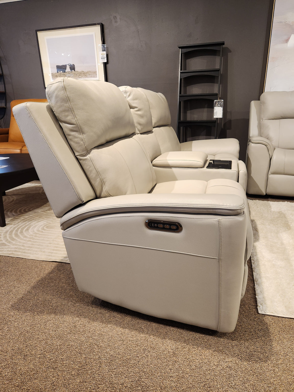 16 WEST Austin Power Recliner Loveseat-520157 with memory foam, cup holders, and control buttons displayed in showroom.