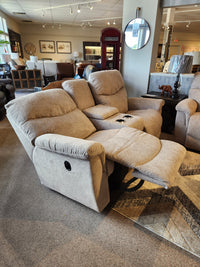 Two beige 521 James Loveseat with console by La-z-boy are in the showroom alongside other seating and decor.