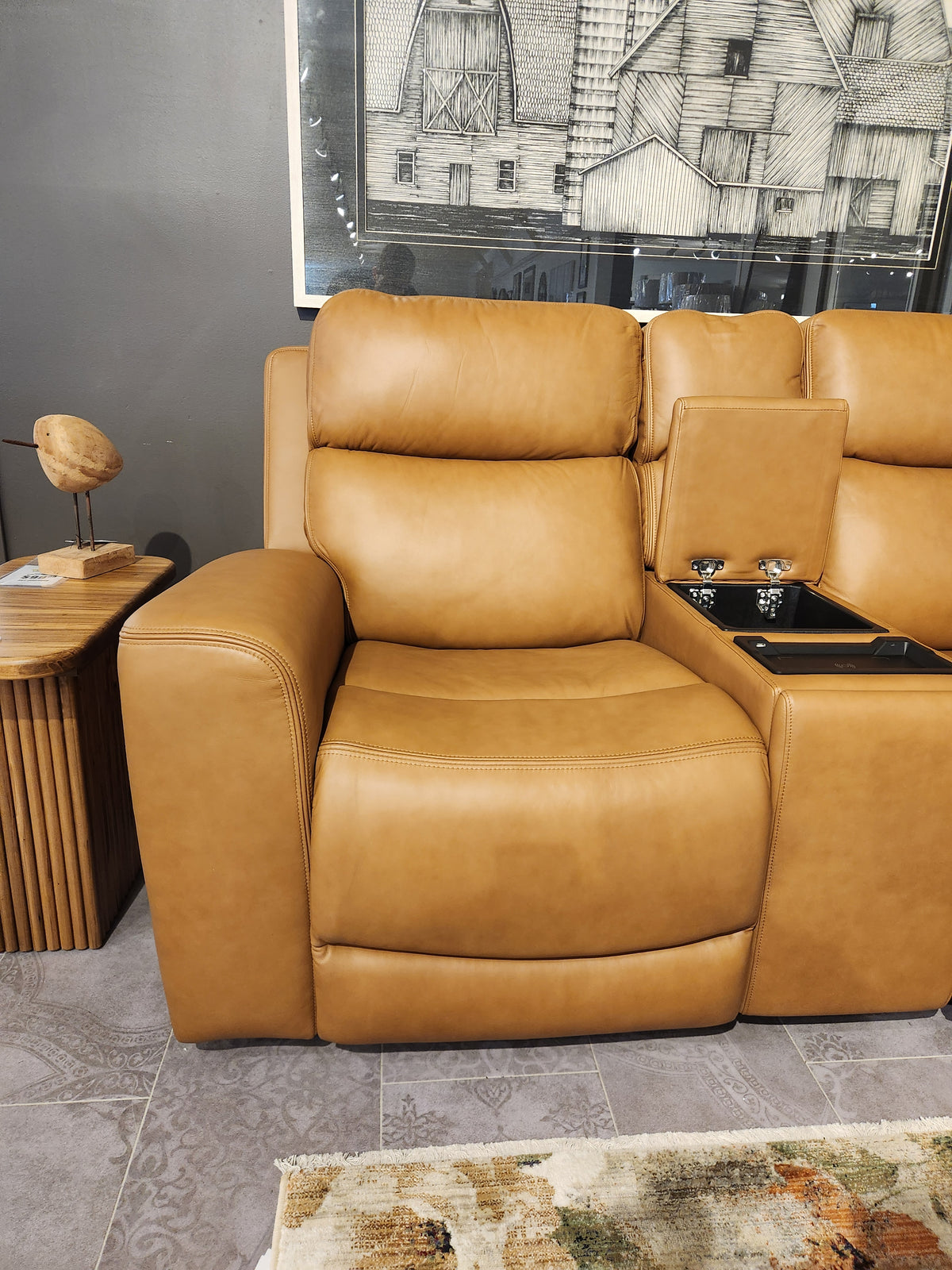 Denver 2 Power Recliner Loveseat by 16 WEST with lumbar support and cup holder, beside a table and wall art.