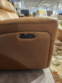 Close-up of a Denver 2 Power Recliner Sofa armrest by 16 WEST with electronic controls in a furniture store.