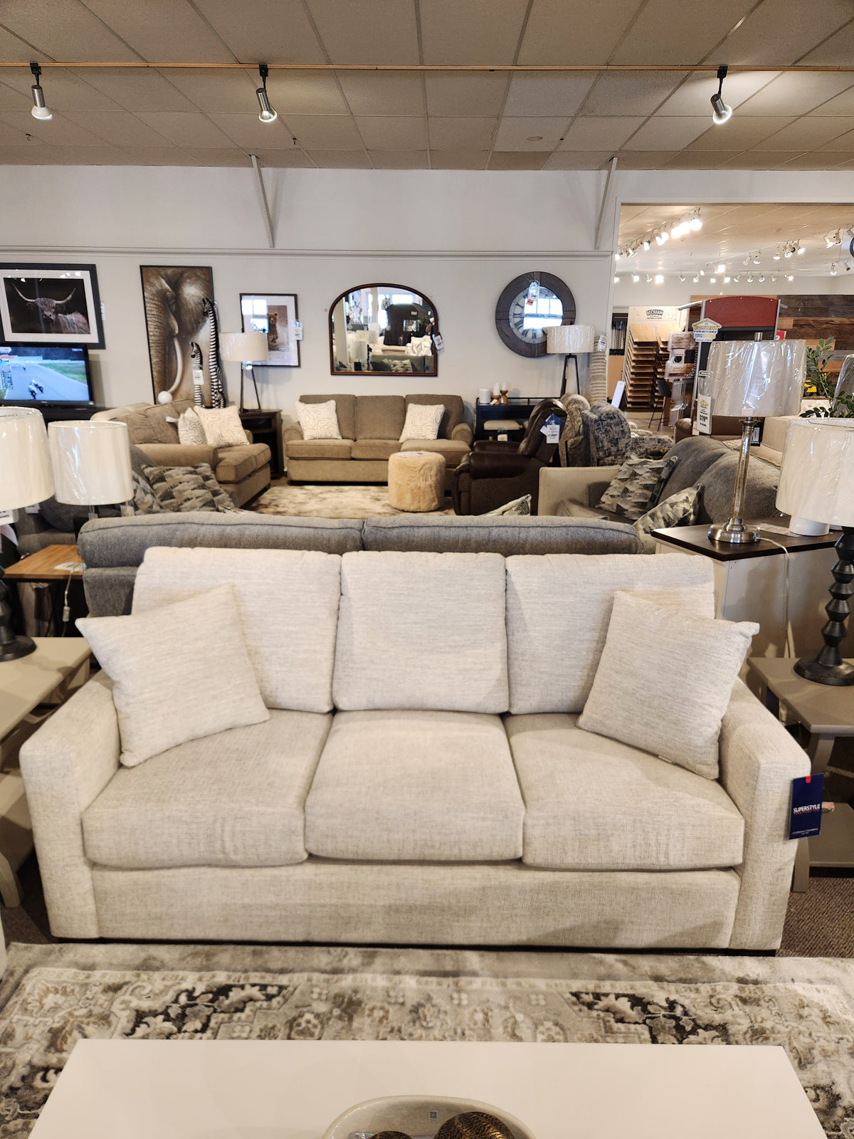 Superstyle 9540 Stationary Sofa: beige, cushioned back, three seats; shown in a chic modern living room.