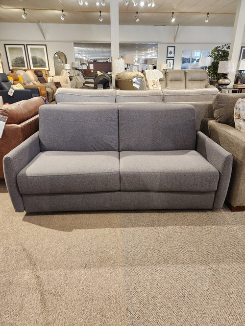 Vitale Sofa Bed by Primo: gray upholstery, Italian mechanism, and memory foam displayed with couches in the showroom.