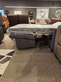 The Primo Vitale Sofa Bed features a memory foam mattress and Italian mechanism, displayed in a modern showroom.