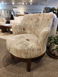 Best Ronan 2908 Swivel Chair with wood swivel base, upholstered, shown in a furniture showroom on carpeted floor.
