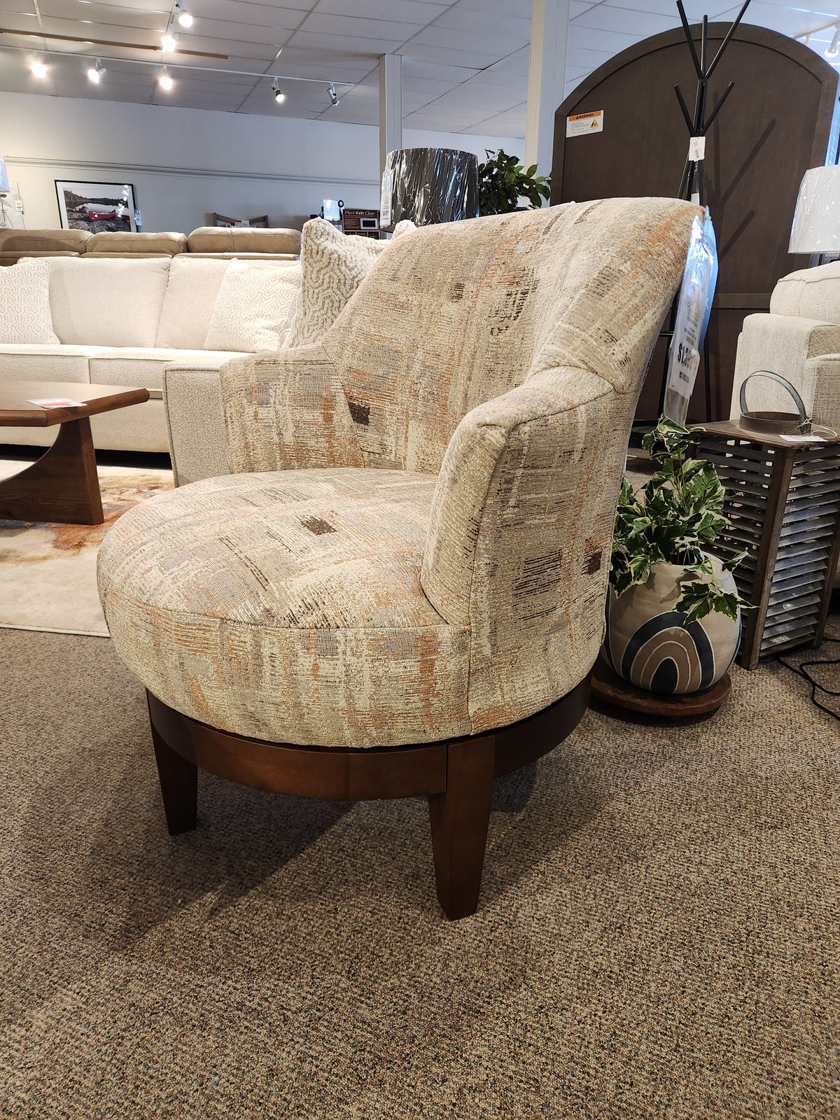 Best Ronan 2908 Swivel Chair: Upholstered accent seat with wood swivel base, showcased among home decor in showroom.