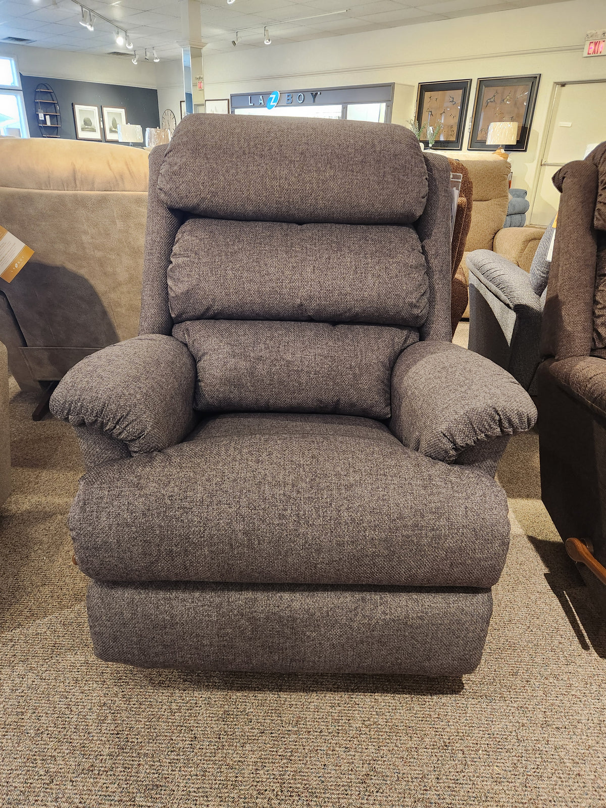 La-z-boy 519 Astor Rocker Recliner with adjustable back cushions displayed among other chairs in a showroom.