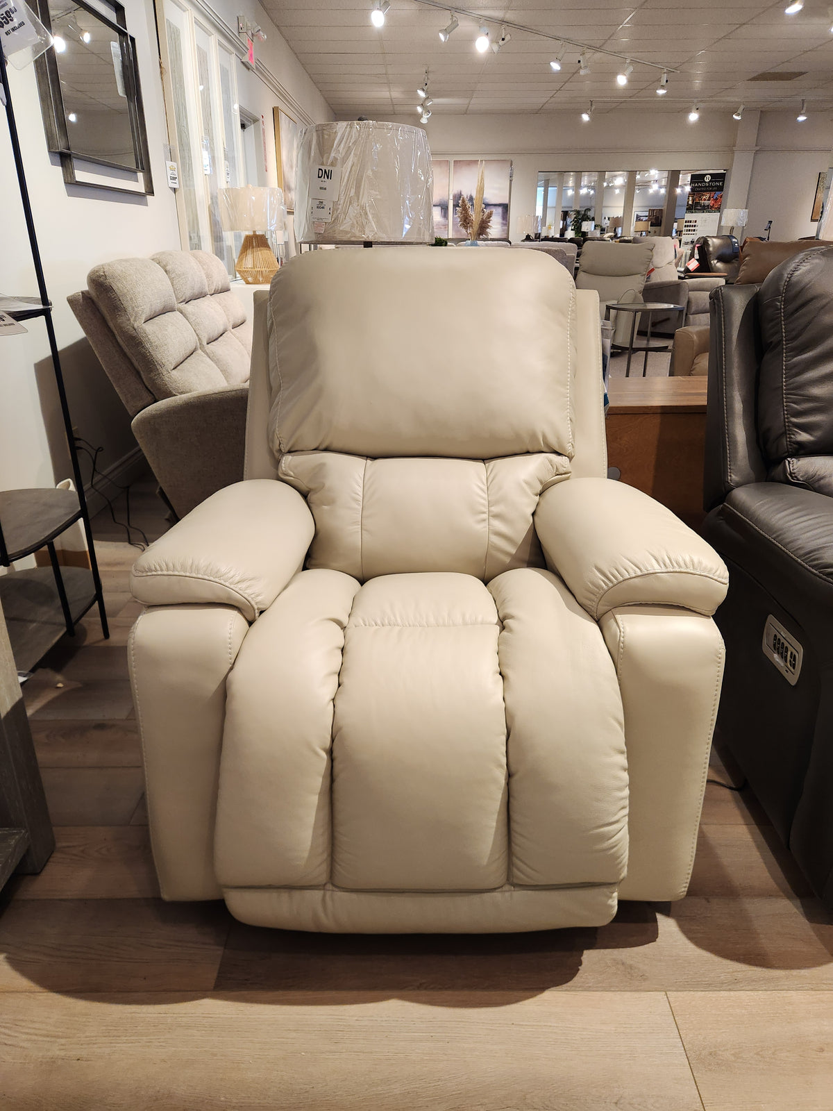 The La-Z-Boy 530 Greyson Power Rocking Recliner is displayed with other chairs in a modern furniture showroom.