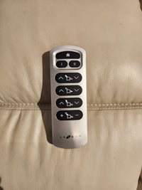 Silver La-Z-Boy remote with black buttons, made for 530 Greyson Power Rocking Recliner, sits on light leather.