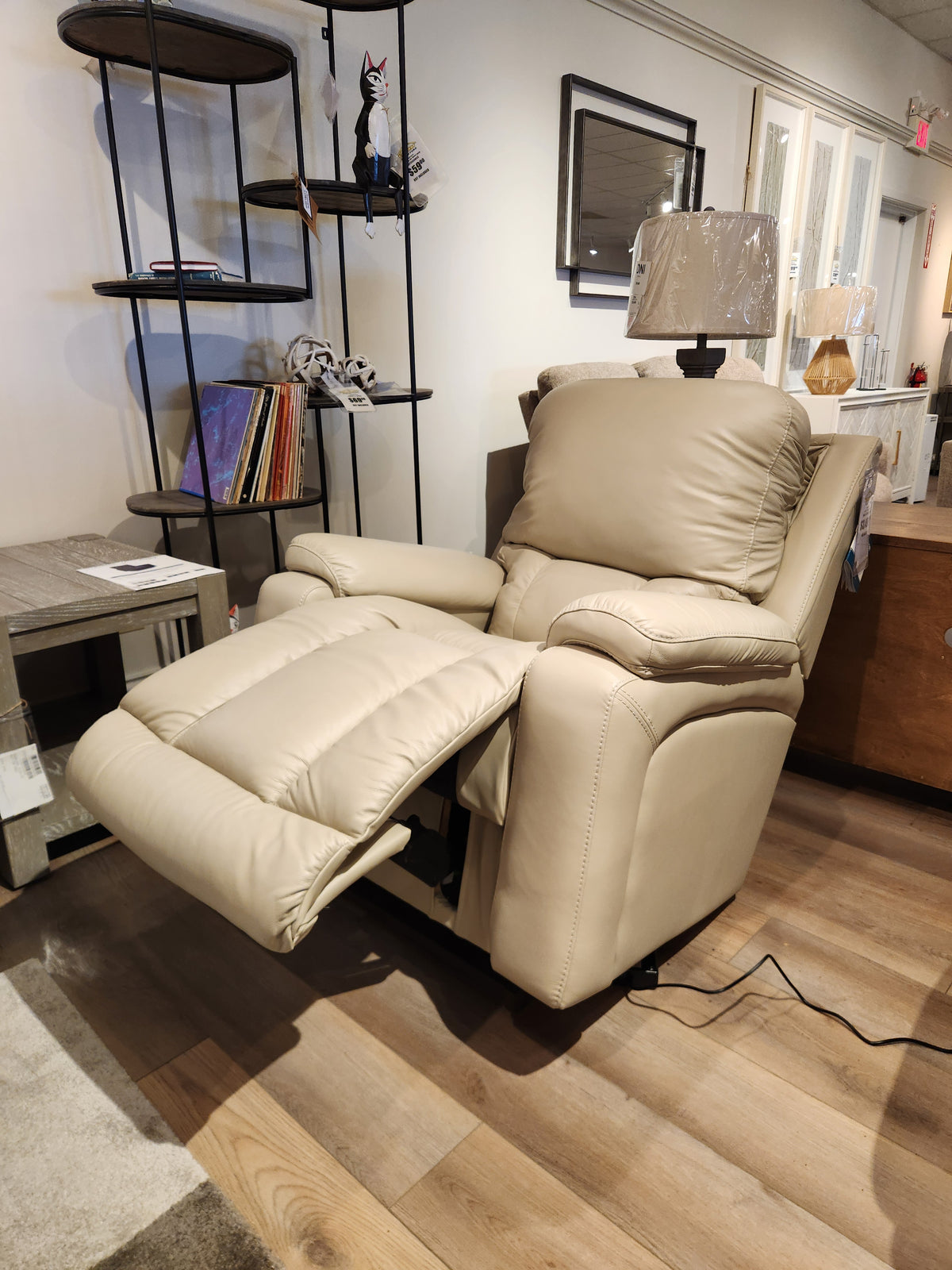 La-z-boy 530 Greyson Power Rocking Recliner in beige with headrest and lumbar support, footrest out, in showroom.