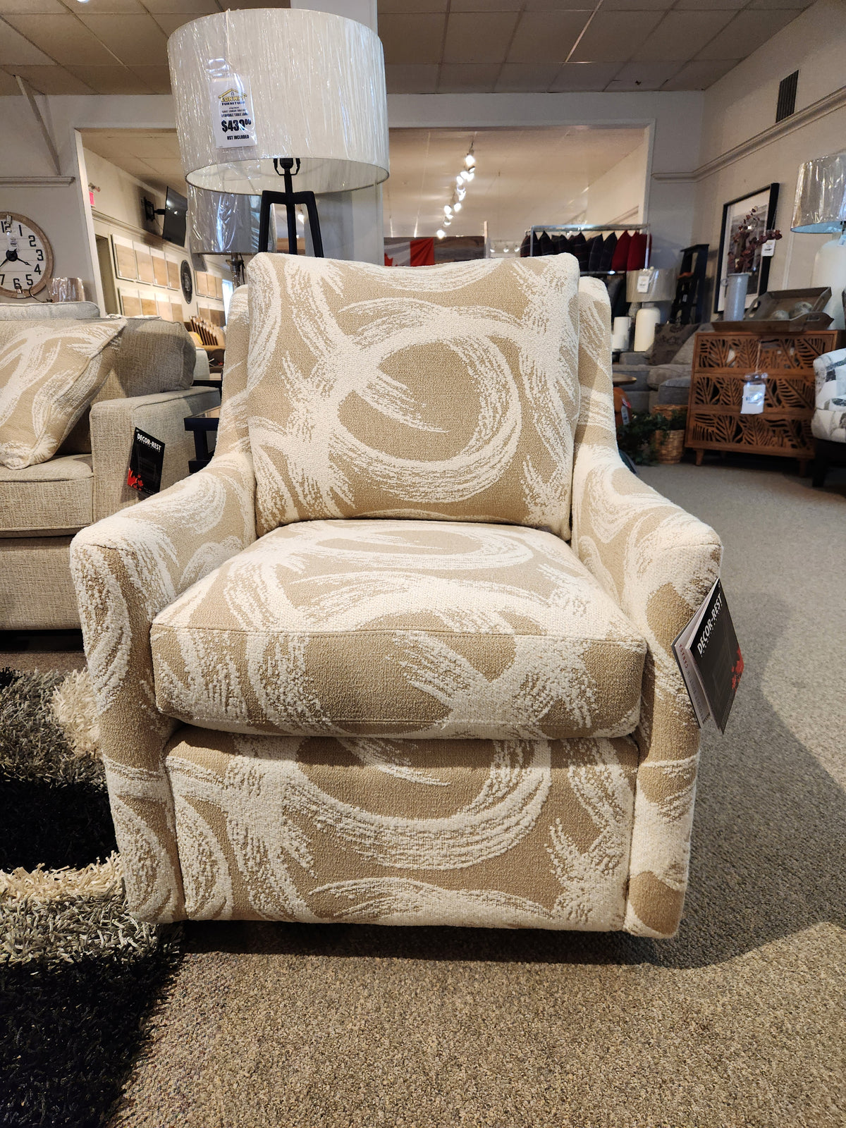 Decor-rest 2627 Swivel Accent Chair in beige with white swirls, slim sloped arms—ideal for small spaces; price tag attached.