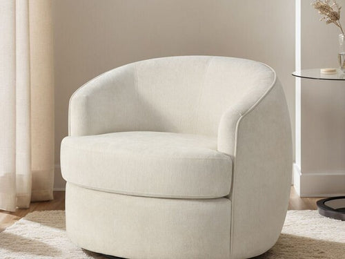 The B6513 Sloane Swivel Chair by Donald Choi adds comfort beside a glass table in a modern, neutral room.