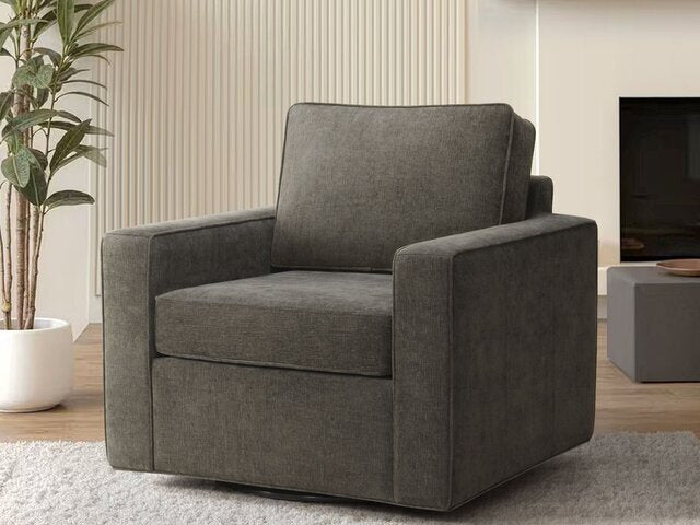 The B6517 Skyler Swivel Chair by Donald Choi, dark gray with square arms, sits on a light rug in a modern living room.