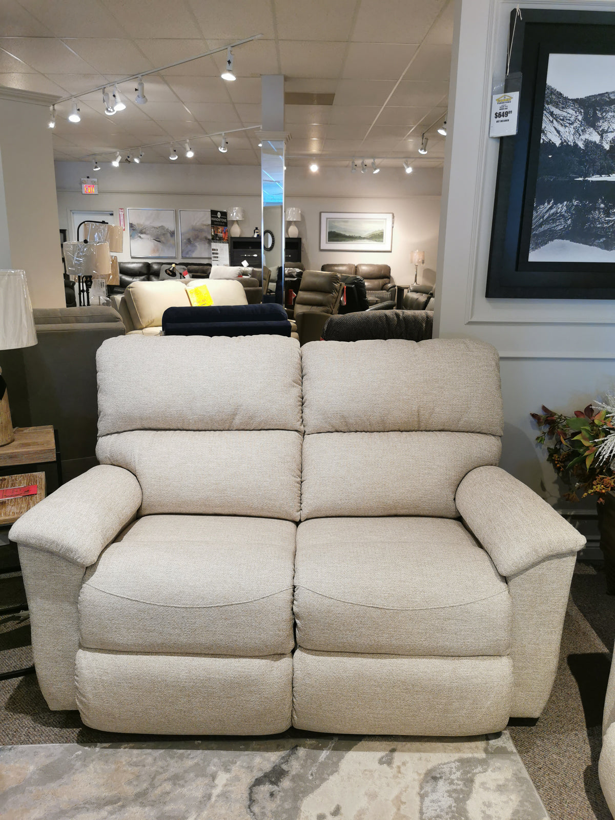 The La-z-boy 727 Brooks Reclining Loveseat in beige offers personalized comfort in a stylish showroom display.