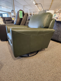 The Leather Craft 745 Leather Swivel Rocker Chair in green sits on a carpeted showroom floor.
