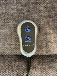 La-Z-Boy 793 Jean Bronze Lift Chair remote with "Lift" and "Recline" buttons on gray upholstery.