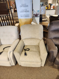 La-z-boy 793 Jean Bronze Lift Chair with remote, shown between two recliners in a furniture store.