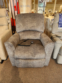 The La-z-boy 793 Jean Bronze Lift Chair with wired remote sits on a carpeted showroom floor between other chairs.