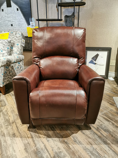 802 Cassian Rocker Recliner by La-z-boy showcased in a modern showroom with wooden floors and additional furniture.