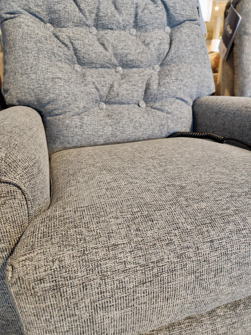 Close-up of the Best 7NW51 Mexi Power Lift Chair with a tufted gray back cushion, shown on display in a store.