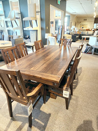 The Handstone RA4284 Rafters Dining Package with 8 chairs adds rustic style to the showroom.