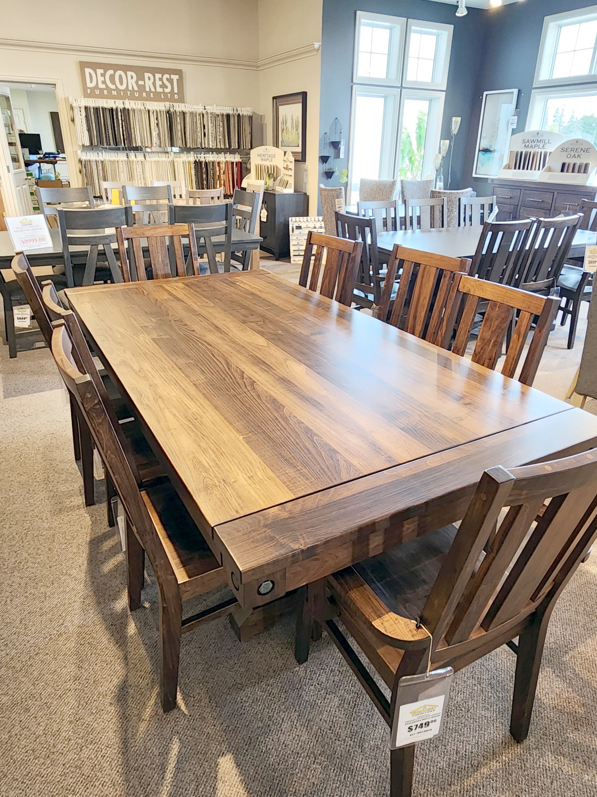 Handstone RA4284 Rafters Dining Package, displayed with rustic chairs and fabric samples in a showroom.