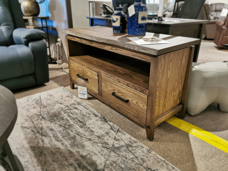 Handstone P48 Pemberton 48" Entertainment Unit with custom metal hardware, open shelf & drawers in showroom.