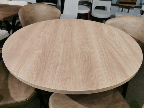 The Amisco 39" Laminate Round Biscotti/Asterisk Table Package in a chic setting with cushioned chairs.