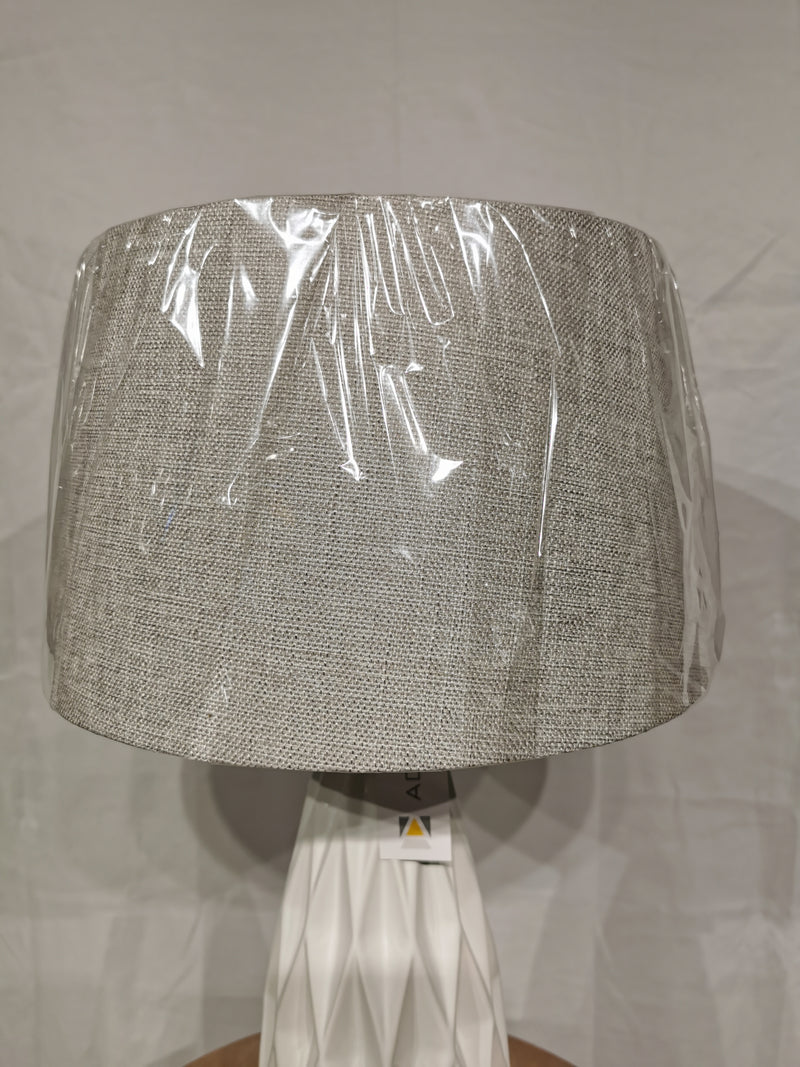 The Adesso Lamp Joan 2 Pack Table Lamp features a ceramic base and fabric shade with protective plastic, shown on plain background.