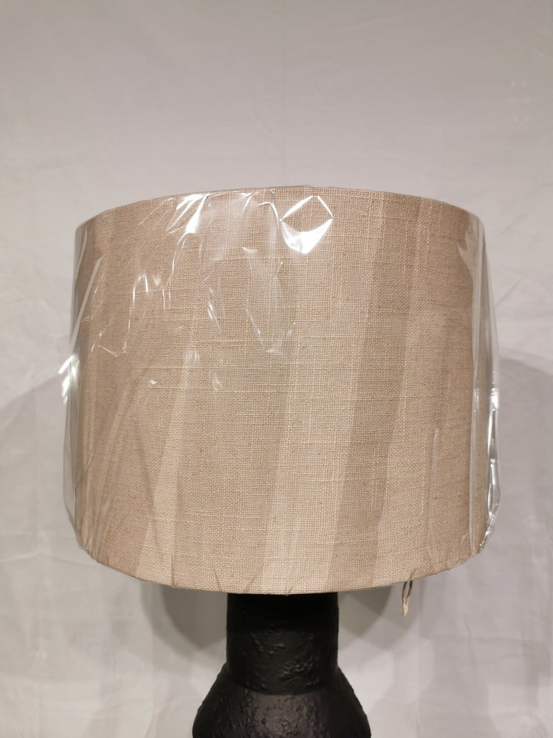 The Adesso Lamp Noelle Table Lamp features a beige fabric shade and black ceramic base for stylish, elegant lighting.