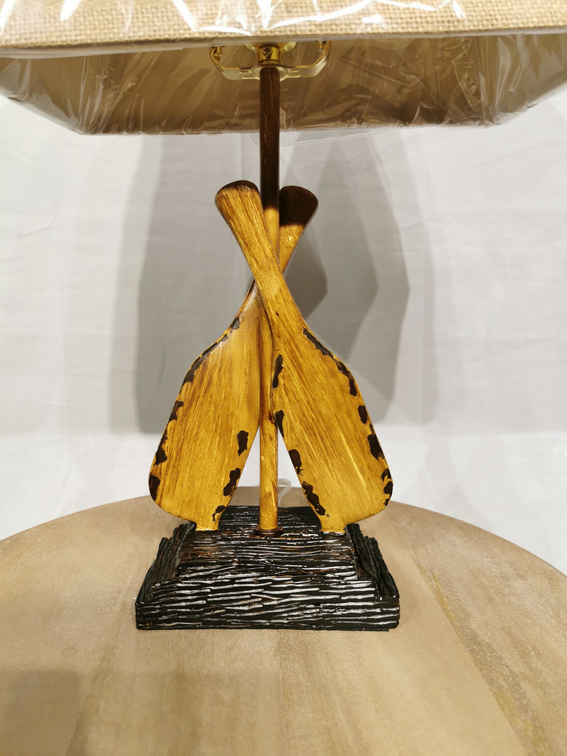Discover the Crestview Collection's Oar Accent Table Lamp, featuring a boating-style wooden base and beige lampshade.