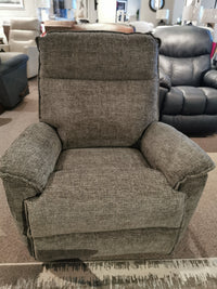 A gray La-z-boy 706 Jay Rocker Recliner, made in America, is displayed with other chairs in the showroom.
