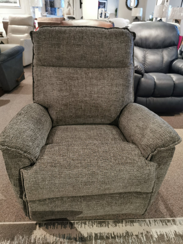 A gray La-z-boy 706 Jay Rocker Recliner, made in America, is displayed with other chairs in the showroom.