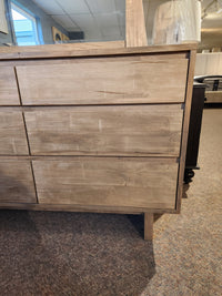 Handstone JA18 6 Drawer Dresser in light wood from the Jasper Collection, shown with lamp on top in carpeted room.