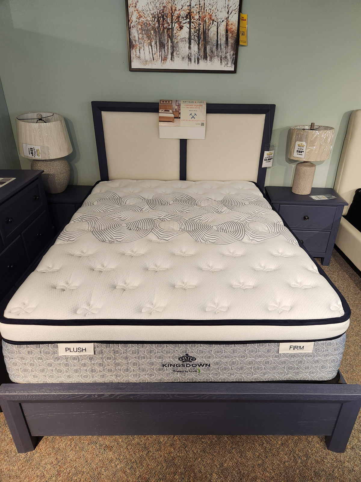 A queen-size KingsDown Radiance Elite 2 ET Firm Mattress offers cooling comfort, flanked by nightstands with lamps.
