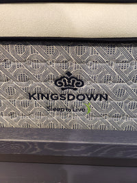 Close-up of a KingsDown Radiance Elite 2 ET Firm Mattress label with patterned, cooling comfort fabric.
