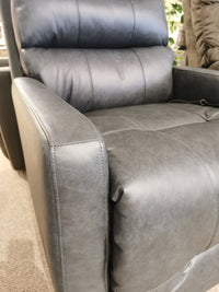 Close-up of the Best Kristisha 9NZ31LV gray leather power lift chair with modern silhouette on a carpeted floor.