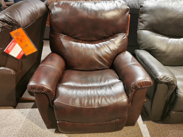 A La-z-boy 521 James Rocker Recliner in brown with padded arms, bucket seat, and tag, shown in the showroom.