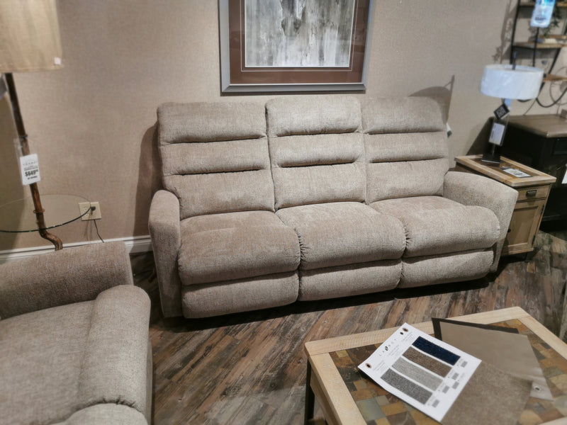 The La-Z-Boy 786 Liam Beige Reclining Sofa with chaise and matching chair, art above, and wood side tables on view.