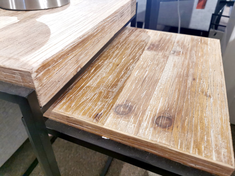 Close-up of Mercana's Karissa Nesting Tables, featuring wood grain and distress marks with sturdy metal frames.