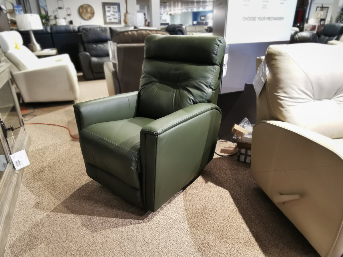 The Palliser 43003 Denali Swivel Power Glider in green leather is displayed among other living room furniture.