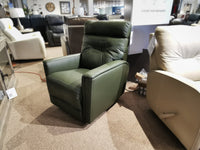 The Palliser 43003 Denali Swivel Power Glider in green leather is displayed among other living room furniture.