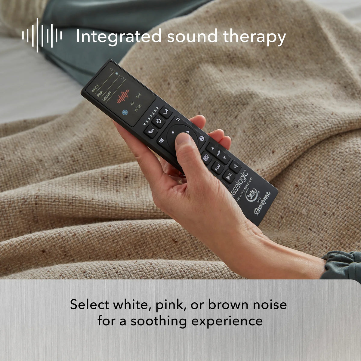 A hand holds a remote on a brown blanket, highlighting Beauty-Rest’s Platinum Adjustable Base with sound therapy features.