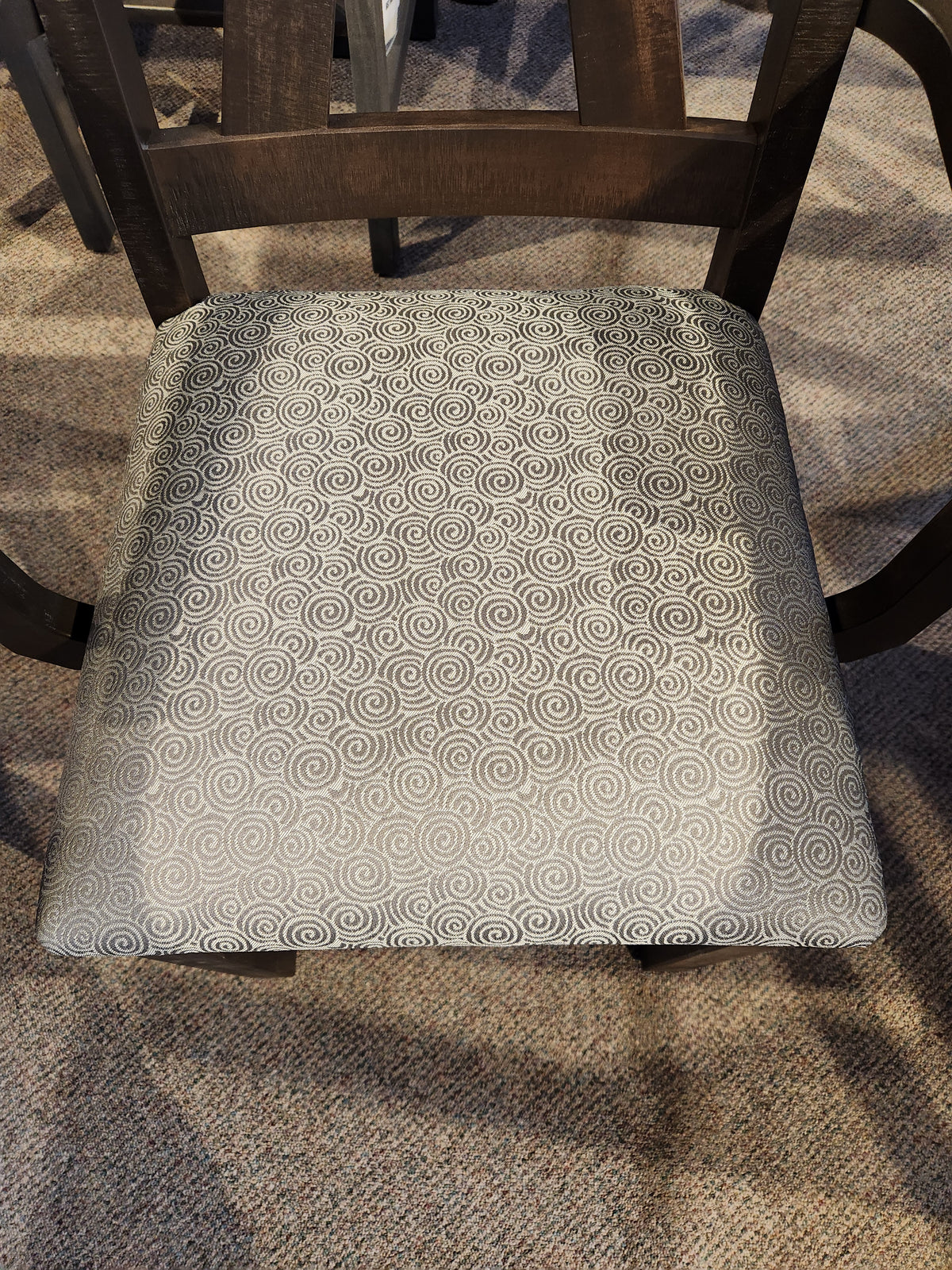 A Handstone Rafters chair: dark wood, light gray spiral cushion—RA4284 Dining Package.