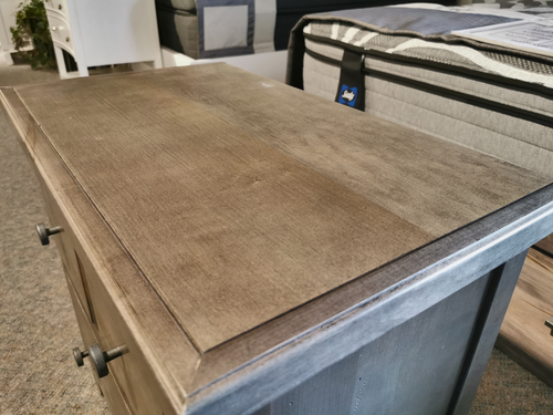 801 Cool Farmhouse nightstand by Vaughan Bassett, next to a mattress display in the showroom.