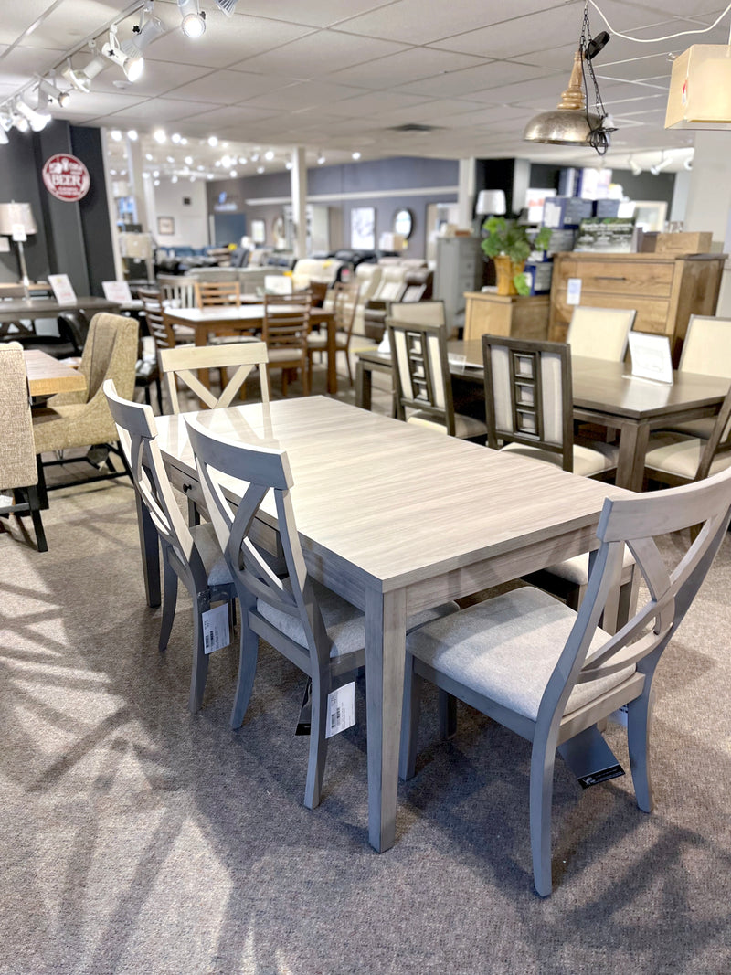 The Ashley D291 Parellen Dining Set, featuring a table and six chairs, is displayed in the showroom.